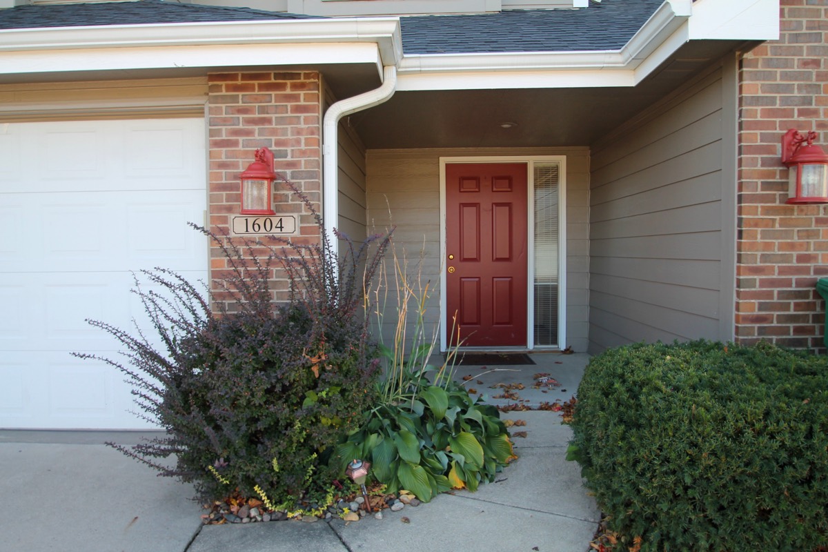 Brick entry with a red front door at The Pines